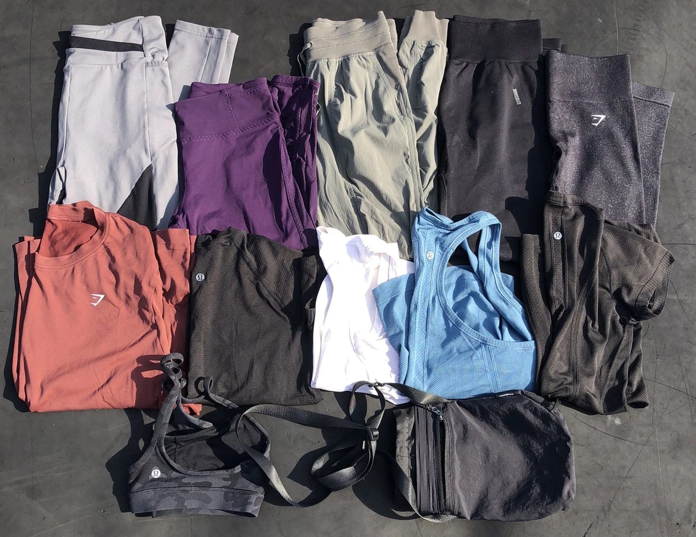 Flat-lay of pre-owned lululemon sports bras from a ThriftUp wholesale lot